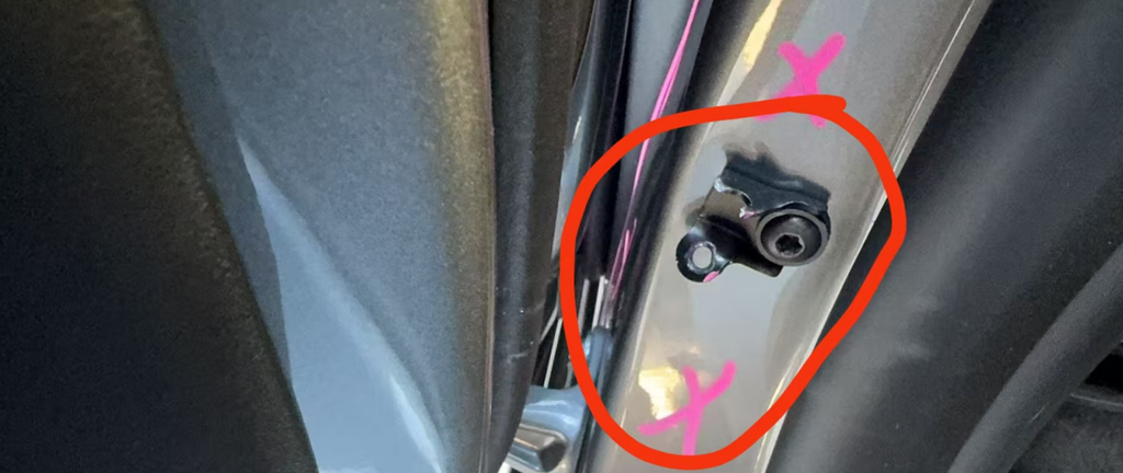 Behind Tesla MY door stopper